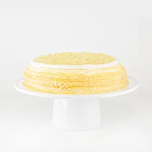 A Lady M Champagne Mille Crêpes on top a white cake stand.