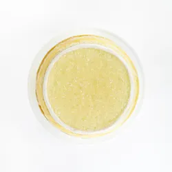 A top-down shot of a Lady M Champagne Mille Crêpes on top a white cake stand.