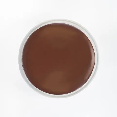 A top-down shot of a Lady M Checkers on top a white cake stand.