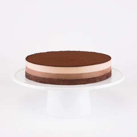 A Lady M Chocolate Arc-en-Ciel on top a white cake stand.