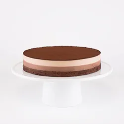 A Lady M Chocolate Arc-en-Ciel on top a white cake stand.