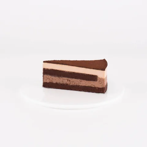 A Lady M Chocolate Arc-en-Ciel slice on top a white round plate.