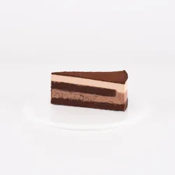 A Lady M Chocolate Arc-en-Ciel slice on top a white round plate.
