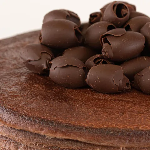 Detail shot of Lady M's Chocolate Mille Crêpes. Layers of crêpe, cream, and chocolate curls.