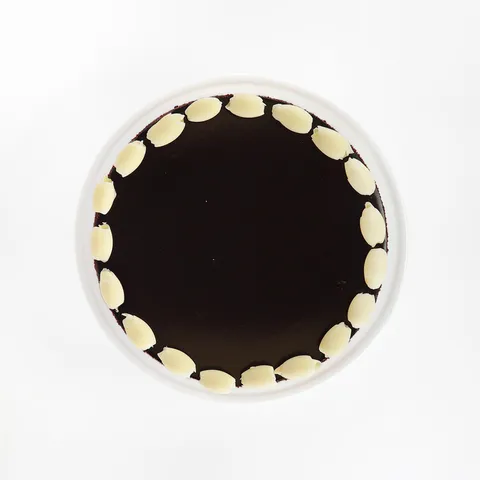 A top-down shot of a Lady M Couronne du Chocolat on top a white cake stand.