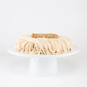 A Lady M Gâteau aux Marrons on top a white cake stand.