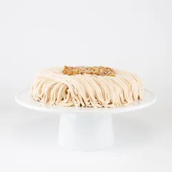 A Lady M Gâteau aux Marrons on top a white cake stand.