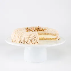 A sliced into Lady M Gâteau aux Marrons on top a white cake stand.