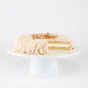 A sliced into Lady M Gâteau aux Marrons on top a white cake stand.