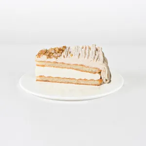 A Lady M Gâteau aux Marrons slice on top a white round plate.