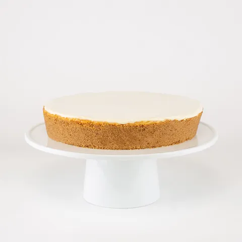 A Lady M Gâteau Nuage on top a white cake stand.