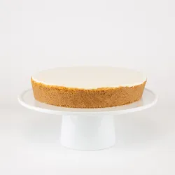 A Lady M Gâteau Nuage on top a white cake stand.