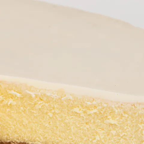 Detail shot of Lady M's Gâteau Nuage. Layers of graham crust, cheesecake, and sweetened sour cream.