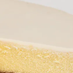 Detail shot of Lady M's Gâteau Nuage. Layers of graham crust, cheesecake, and sweetened sour cream.