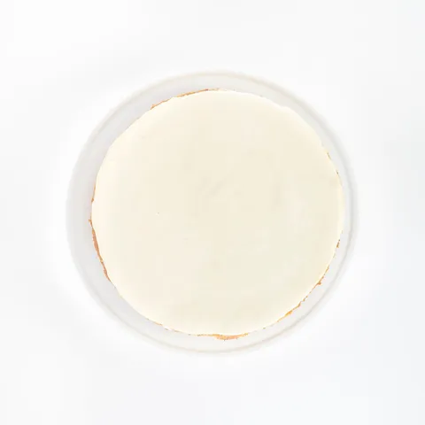 A top-down shot of a Lady M Gâteau Nuage on top a white cake stand.