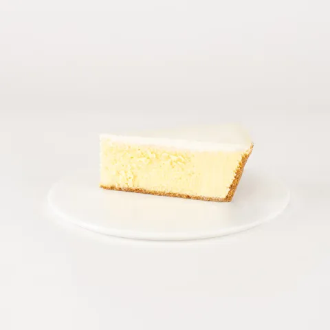 A Lady M Gâteau Nuage slice on top a white round plate.