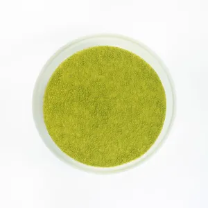 A top-down shot of a Lady M Green Tea Mousse Cake on top a white cake stand.