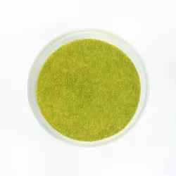 A top-down shot of a Lady M Green Tea Mousse Cake on top a white cake stand.