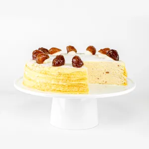 A sliced into Lady M Marron Mille Crêpes on top a white cake stand.