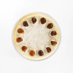 A top-down shot of a Lady M Marron Mille Crêpes on top a white cake stand.