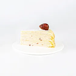 A Lady M Marron Mille Crêpes slice on top a white round plate.