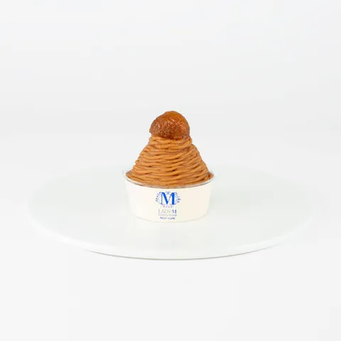 A Lady M Mont Blanc on top a white round plate.