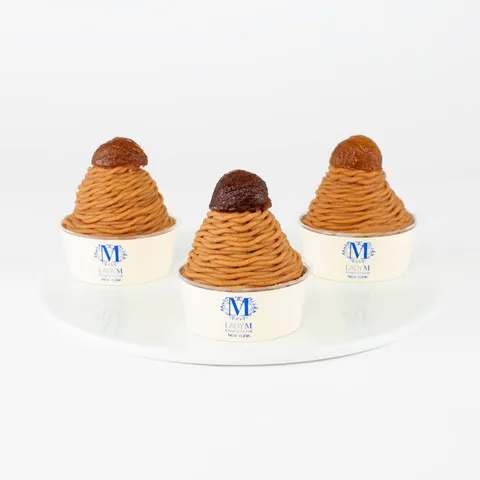 Three Lady M Mont Blanc on top a white round plate.