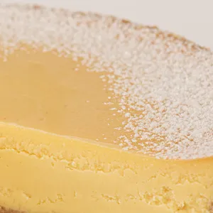 Detail shot of Lady M's Passion Fruit Cheesecake. Graham crust, cream cheese, & passion fruit purée.