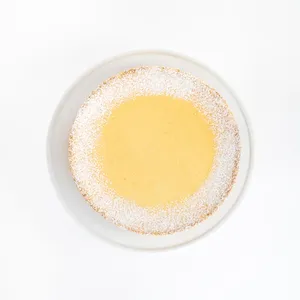 A top-down shot of a Lady M Passion Fruit Cheesecake on top a white cake stand.