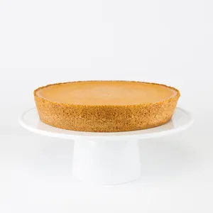 A Lady M Pumpkin Nuage on top a white cake stand.