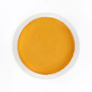 A top-down shot of a Lady M Pumpkin Nuage on top a white cake stand.