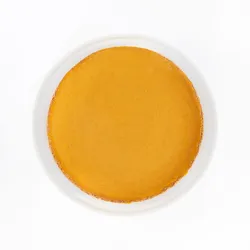 A top-down shot of a Lady M Pumpkin Nuage on top a white cake stand.