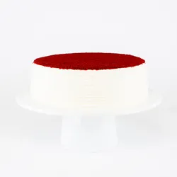 A Lady M Red Velvet on top a white cake stand.