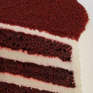 Detail shot of Lady M's Red Velvet. Layers of sponge cake, whipped cream, and cream cheese.