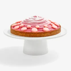 Berry Mont Blanc Tart featuring a tart crust, a four-berry mousse piped high, baby pink macaron shells and powdered sugar.