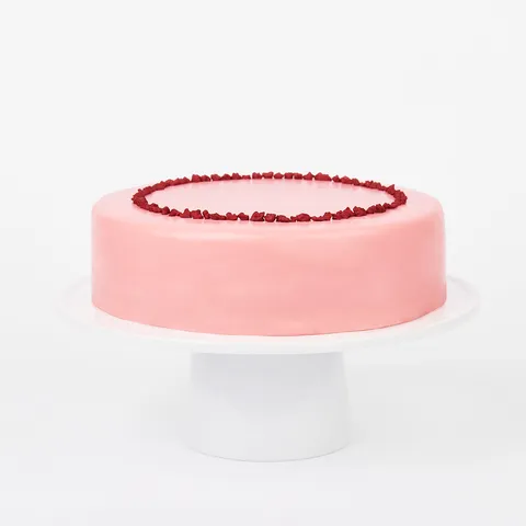 A Lady M Pink Checkers on top a white cake stand.