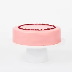 A Lady M Pink Checkers on top a white cake stand.