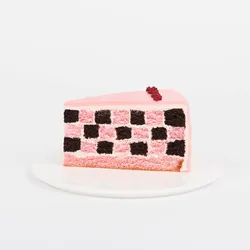 A Lady M Pink Checkers slice on top a white round plate.