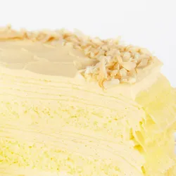 A detail shot of a Lady M Tres Leches Mille Crêpes. Layers of crêpes, cream, and sponge cake.