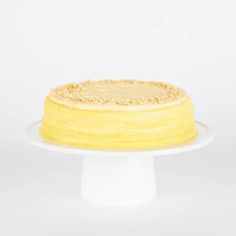 A thumbnail shot of a Lady M Tres Leches Mille Crêpes on top a white cake stand.