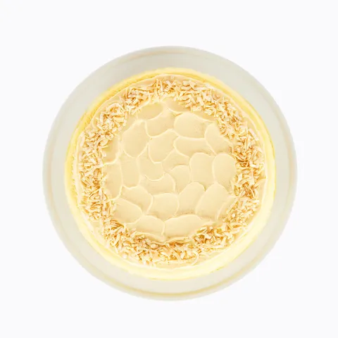 A top-down shot of a Lady M Tres Leches Mille Crêpes on top a white cake stand.