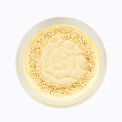 A top-down shot of a Lady M Tres Leches Mille Crêpes on top a white cake stand.