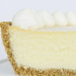 A detail shot of a Lady M Coconut Cheesecake. Layer of graham cracker crust, cream cheese, & purée.