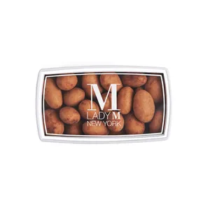 A Lady M Crème Brûlée Almonds Bon Bons encased inside a packaging with a Lady M logo.