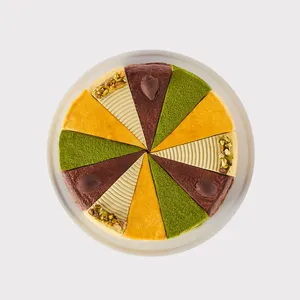 A top-down shot of a Lady M Slice of the Best: Celebration Collection on top a white cake stand.