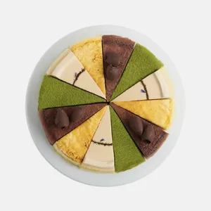 A top-down shot of a Lady M Slice of the Best: Classic Collection on top a white cake stand.