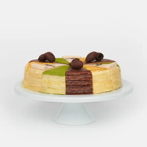 A thumbnail shot of a Lady M Slice of the Best: Classic Collection on top a white cake stand.