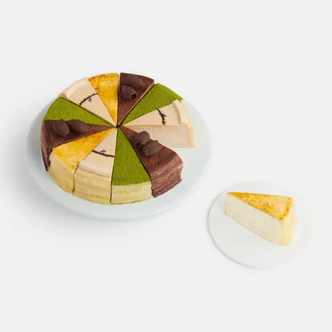 Overhead shot of a sliced into Lady M Slice of the Best: Classic Collection with a slice on a plate.