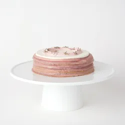 A thumbnail shot of a 6-inch Lady M Lavender Mille Crêpes on top a white cake stand.