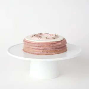 A thumbnail shot of a 6-inch Lady M Lavender Mille Crêpes on top a white cake stand.